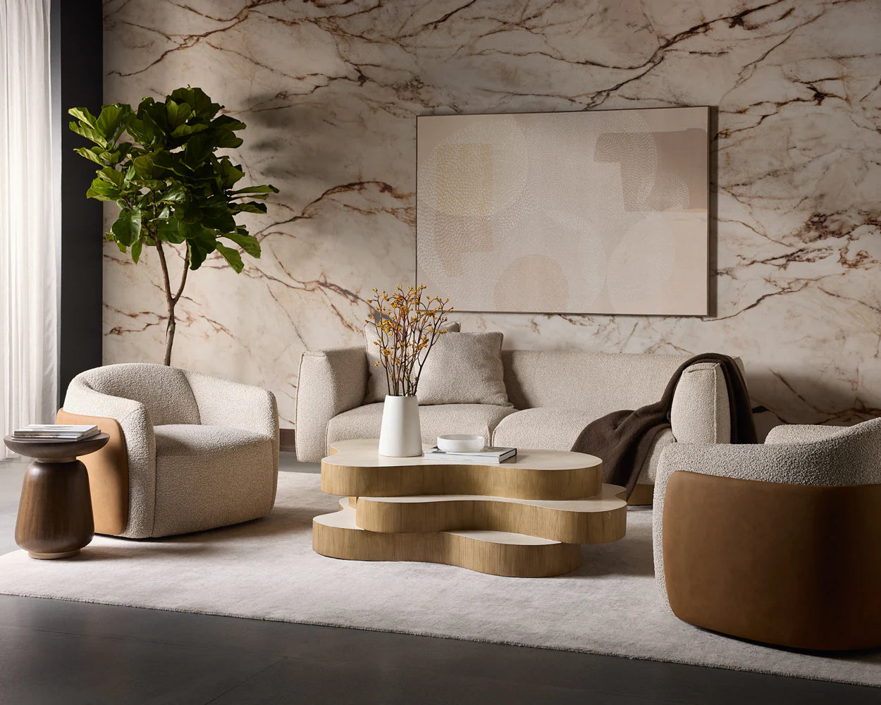 Modern living room with marble wall, sofa, armchairs, and coffee table.